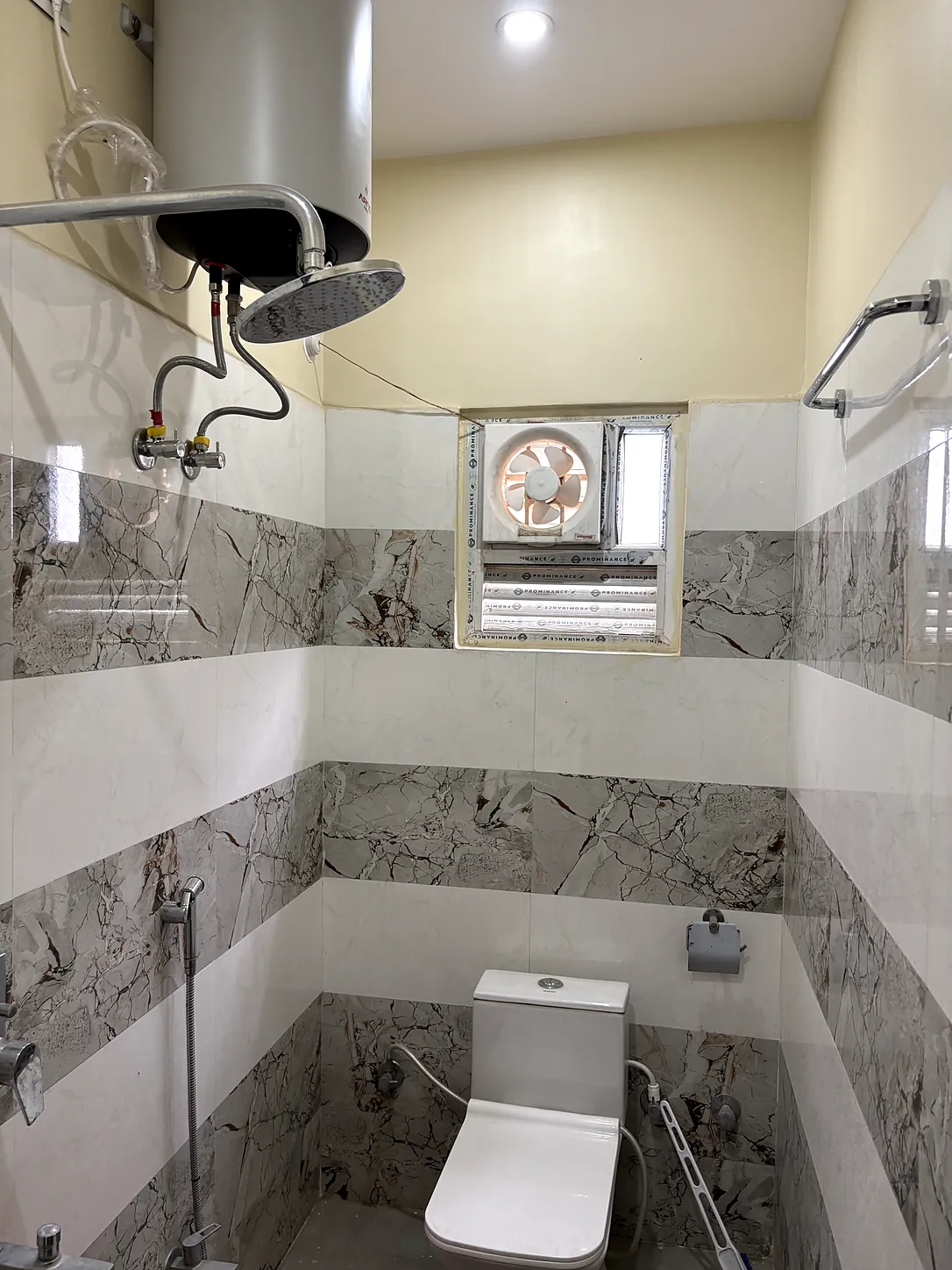 Attached bathroom with marble tiling, rain shower, geyser and western toilet